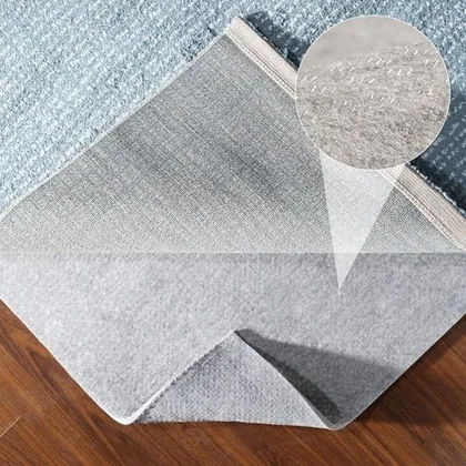 Resare felt rug pad laid back from the edge of a wool rug